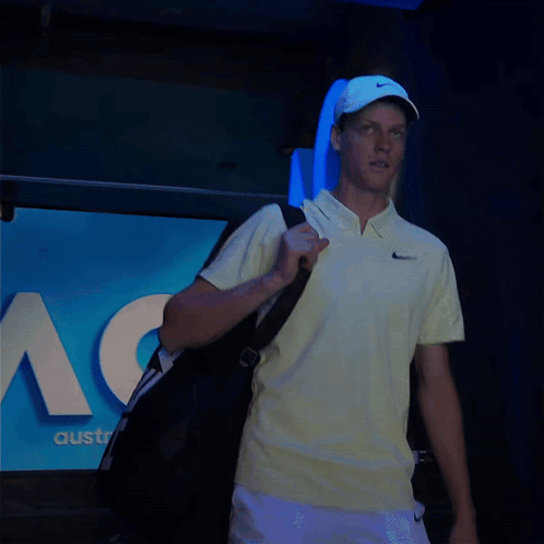 Man In Yellow Nike Shirt Carrying Bag GIF