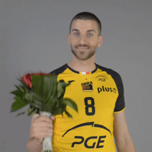 Man in Yellow PGE Shirt Holding Red Roses
