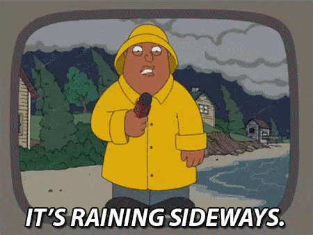 Man In Yellow Raincoat Holding Microphone It's Raining Sideways GIF