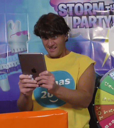 Man in Yellow Shirt 20 Looking at Tablet