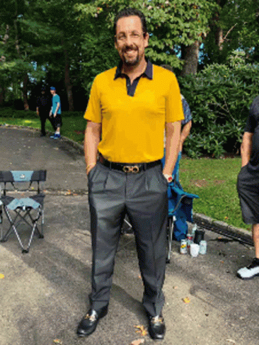 Man in Yellow Shirt and Black Pants in Parking Lot