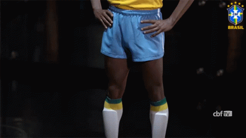 Man in Yellow Shirt and Blue Shorts Hands on Hips Brasil