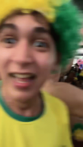 Man In Yellow Shirt And Green Hat Smiling GIF