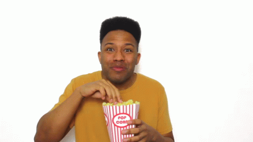 Man in Yellow Shirt Holding Popcorn