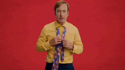 Man in Yellow Shirt Holding Tie Snappy