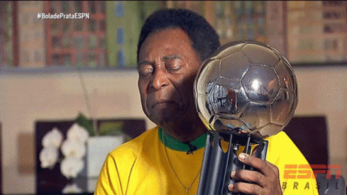 Man In Yellow Shirt Holding Trophy With ESPN Logo GIF