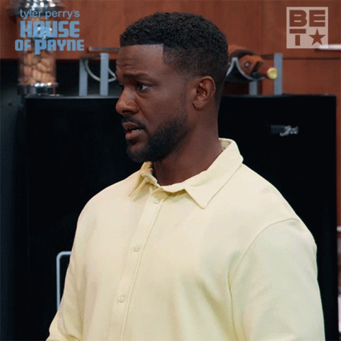 Man in Yellow Shirt in Front of Refrigerator Saying Be