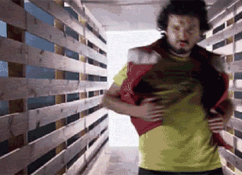 Man In Yellow Shirt In Wooden Hallway GIF