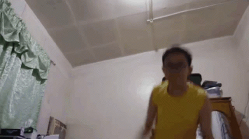 Man in Yellow Shirt Jumping