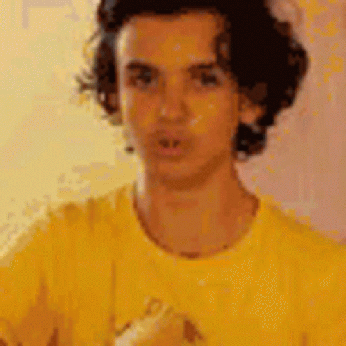 Man in Yellow Shirt Looking at Camera
