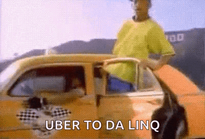 Man in Yellow Shirt Next to Uber Car
