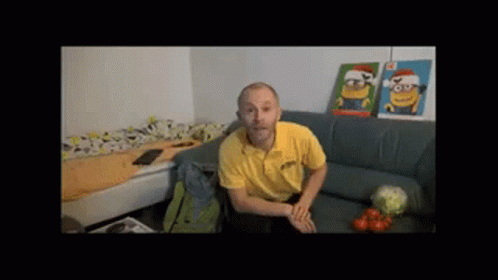 Man in Yellow Shirt on Couch with Two Minion Pictures