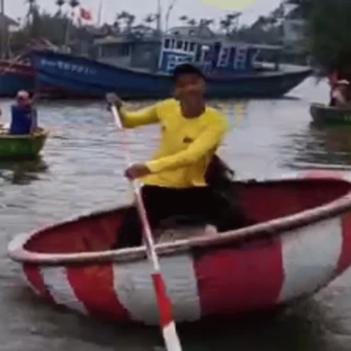 Man in Yellow Shirt Rowing Red and White Boat