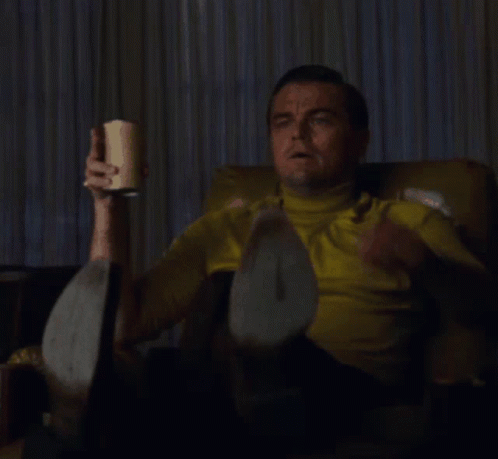 Man in Yellow Shirt Sitting and Pointing