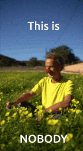 Man in Yellow Shirt Sitting in Yellow Flowers This Is Nobody