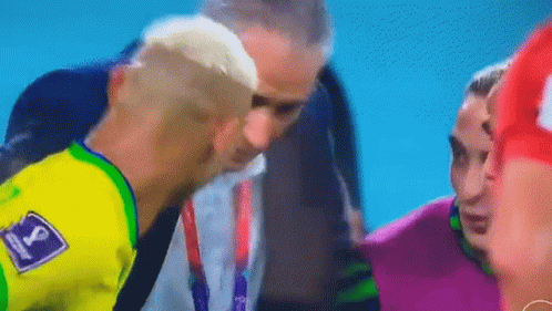 Man in Yellow Shirt Talking to Soccer Player