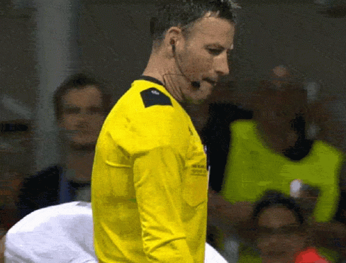 Man In Yellow Shirt With Microphone In Front Of Crowd GIF