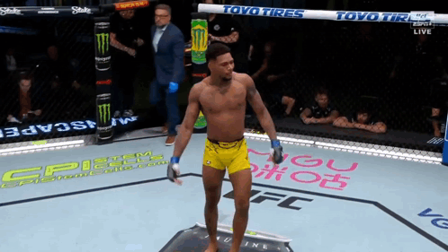 Man In Yellow Shorts In Boxing Ring With Toyo Tires GIF