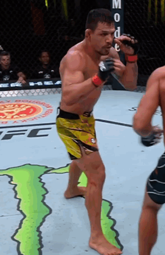 Man in Yellow Shorts in Front of Monster Energy Ad