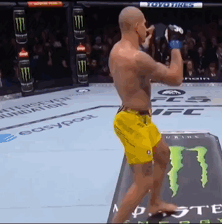 Man in Yellow Shorts Standing in Front of Monster Energy Can