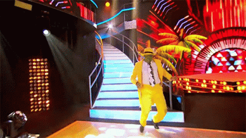 Man in Yellow Suit and Hat Dancing on Stage