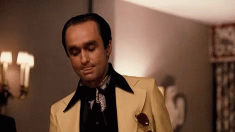 Man in Yellow Suit in Front of Lamp