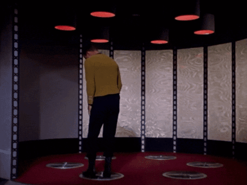 Man in Yellow Sweater in Room with Red Lights