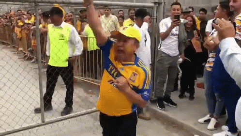 Man in Yellow Tigres Shirt Dancing
