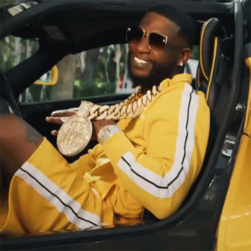Man In Yellow Tracksuit Sitting In Car GIF