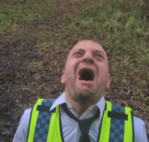 Man in Yellow Vest and Tie Making Face