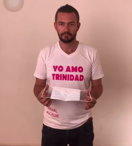 Man in Yo Amo Trinidad Shirt Holding Face Mask