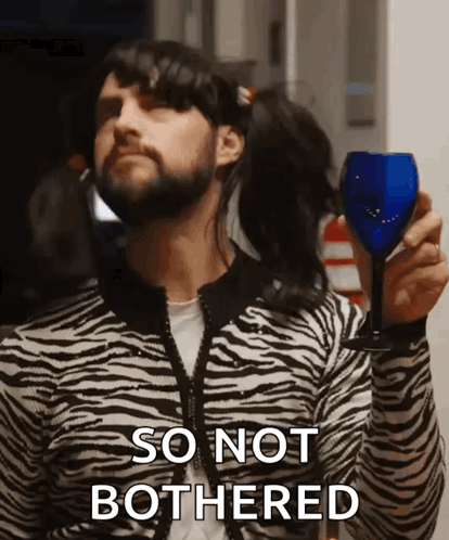 Man in Zebra Print Sweater Holding Wine Saying So Not Bothered