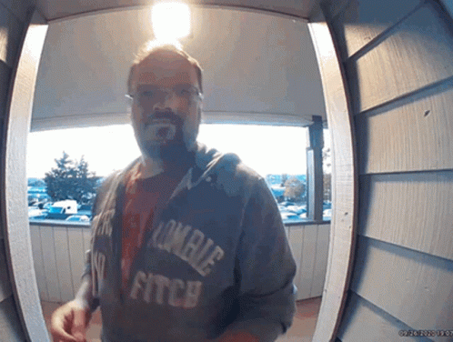 Man In Zombie Fitch Hoodie At Doorway GIF
