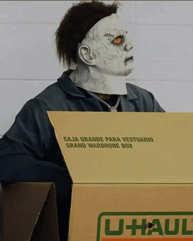 Man in Zombie Mask Holding U-Haul Box