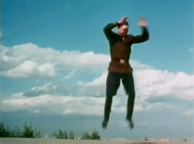 Man Jumping Against Blue Sky and Clouds