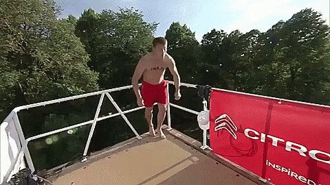 Man Jumping Into Water With Citroen Sign