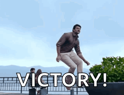 Man Jumping Over Fence with Victory