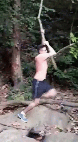 Man Jumping Over Rock with Rope