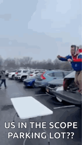 Man Jumping Over Table in Parking Lot Saying Us in the Scope Parking Lot?