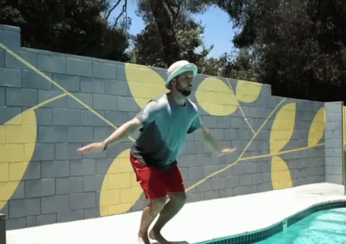 Man Jumps Into Swimming Pool With Hat