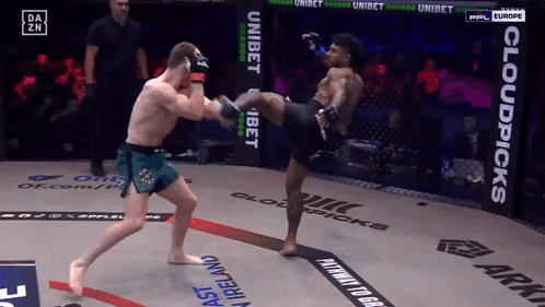 Man Kicking Another Man in Boxing Ring With Cloudpicks