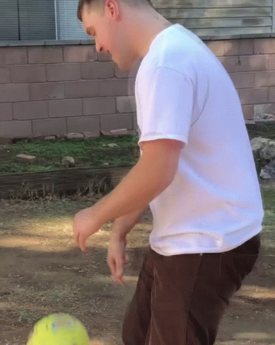 Man Kicking Ball in White Shirt