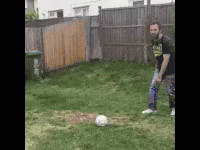 Man Kicking Soccer Ball in Grass