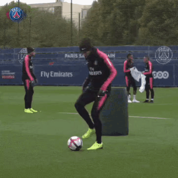 Man Kicking Soccer Ball on Field