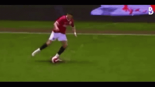 Man Kicking Soccer Ball on Soccer Field