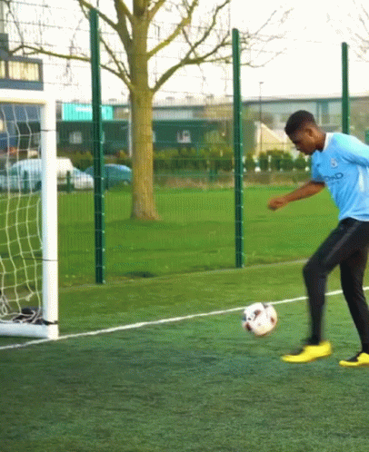 Man Kicking Soccer Ball with City Shirt