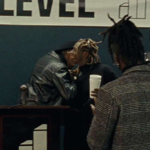Man Kissing Another Man at Level Sign
