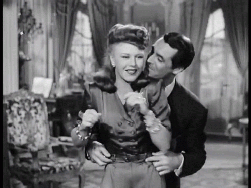 Man Kissing Woman On Cheek Black And White GIF