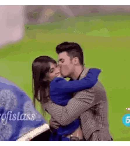 Man Kissing Woman on Cheek