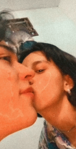Man Kissing Woman On Cheek GIF